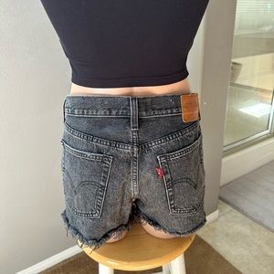 Black 501 Levi button front high rise jean short. Size 28.